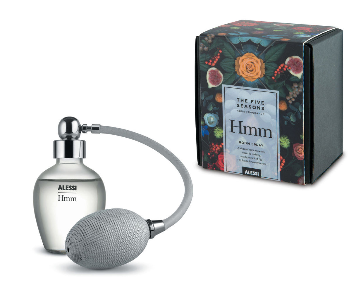 Alessi Hmm roomspray met verstuiver, naast de verpakking met bloemenprint