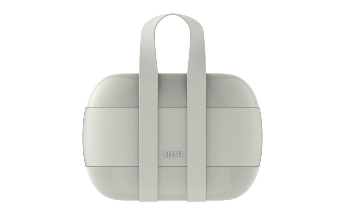 Alessi bento-box in grijs, gesloten met draagriemen, vooraanzicht