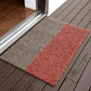 Shiba doormat tiles in red and taupe, in use by door