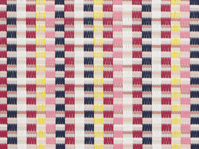 Placemat Heddle Pansy van Chilewich, geweven patroon in roze, rood en geel, close-up van de serie.