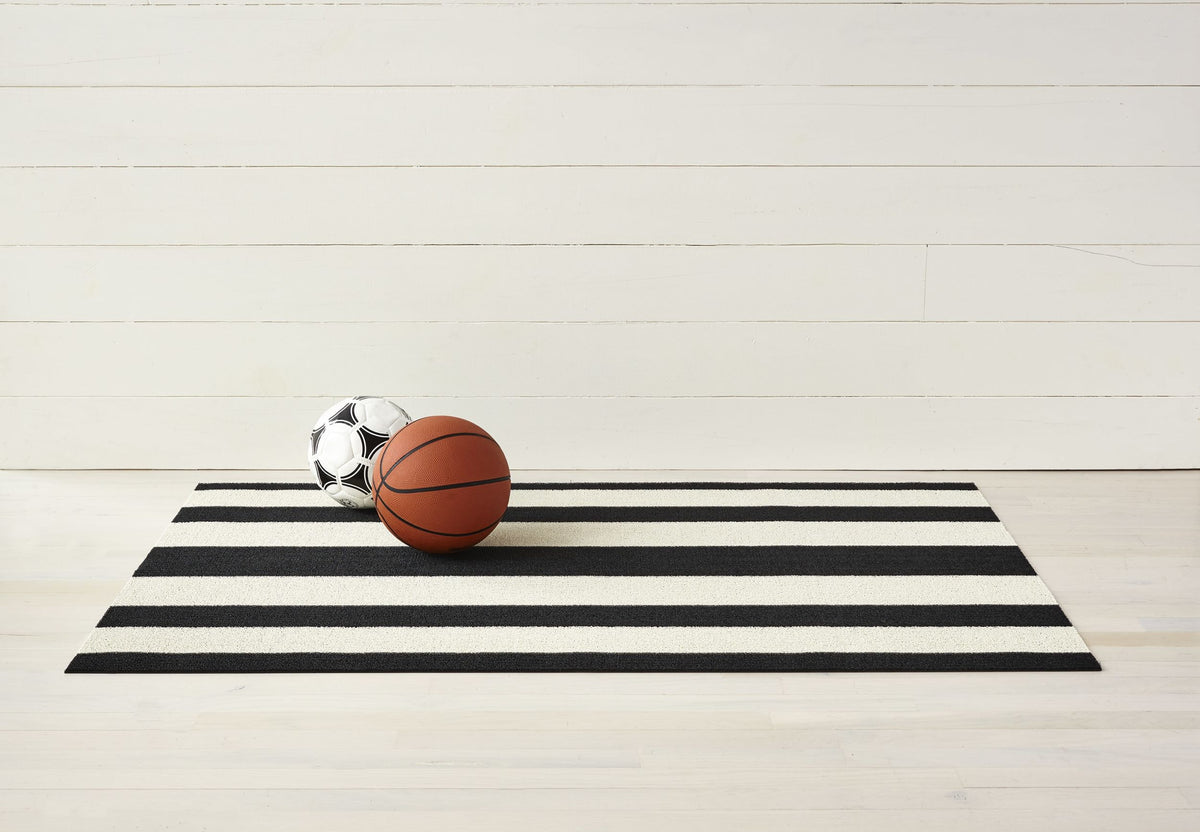 Chilewich doormat with wide black-and-white stripes, ball on top