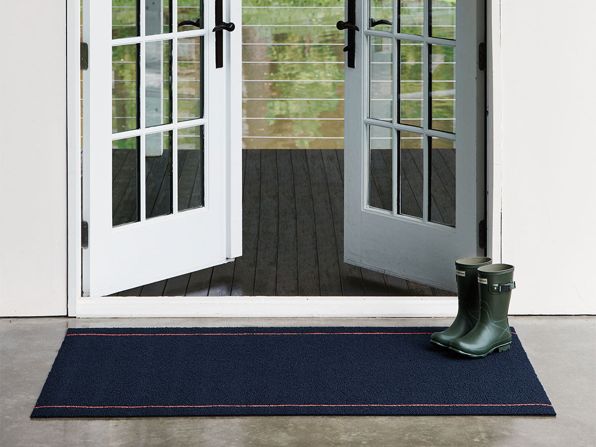 Chilewich doormat in navy blue, placed by French doors