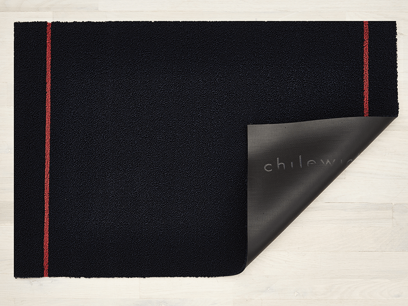 Doormat with folded-back corner, vinyl backing with visible brand logo