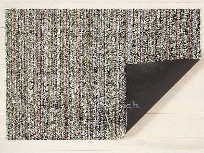 Chilewich Skinny Stripe Soft Multi doormat, detail with folded-back corner and vinyl backing