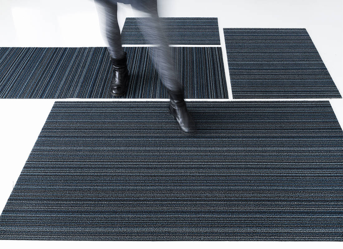 Skinny Stripe Blue doormats by Chilewich placed side by side, in use
