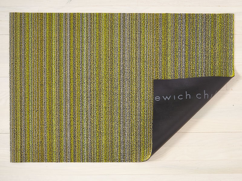 Chilewich Skinny Stripe Citron doormat, folded corner showing black underside