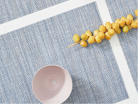 Two Chilewich Thatch Rain placemats in blue-white, woven texture