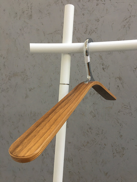 Flu clothes hanger on clothes rack, wide wooden spout and chrome hook