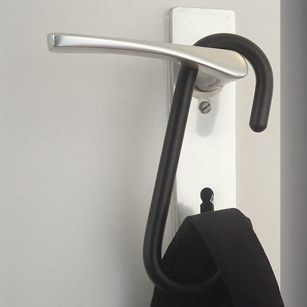 Black hook on wall bracket with bag hanging from it