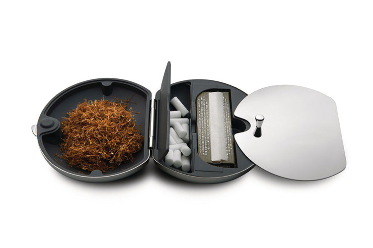 Alessi Taboo tobacco box, open with rolling tobacco, filters and rolling papers