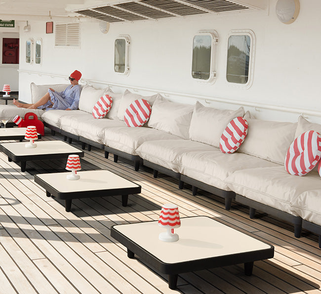 Rode kussens met witte strepen, meerdere exemplaren op een rij op een loungebank
