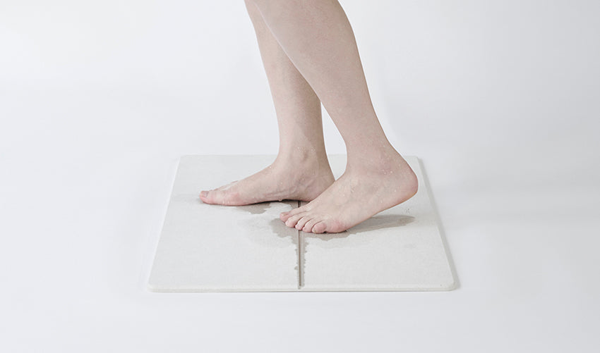 Soil Japanese bath mat, in use under bare feet
