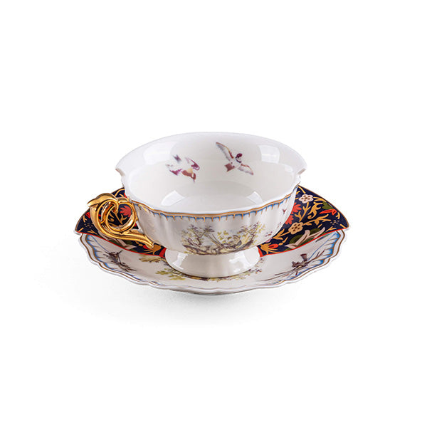 Teacup and saucer by Seletti, designed by CTRLZAK, with flower and bird motif and gold handle