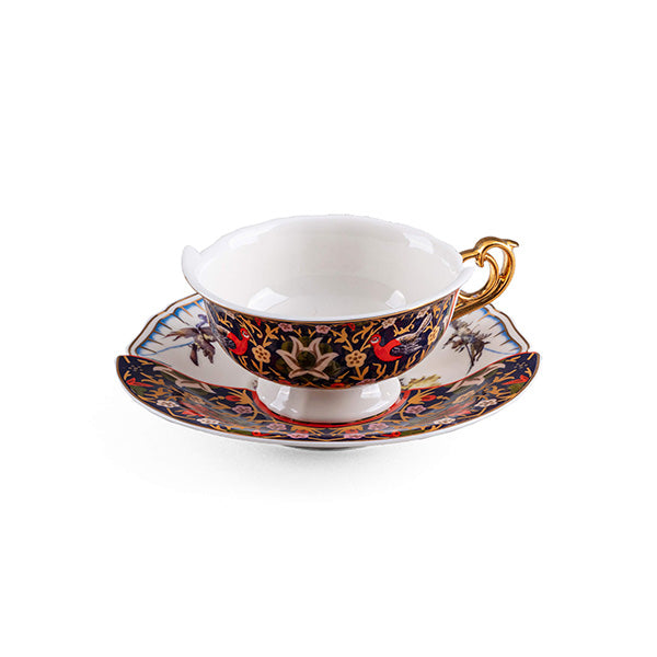 Teacup and saucer, side view with gold handle and dark blue floral motif