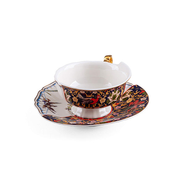 Cup and saucer, with gold handle on right and floral motif in red and blue