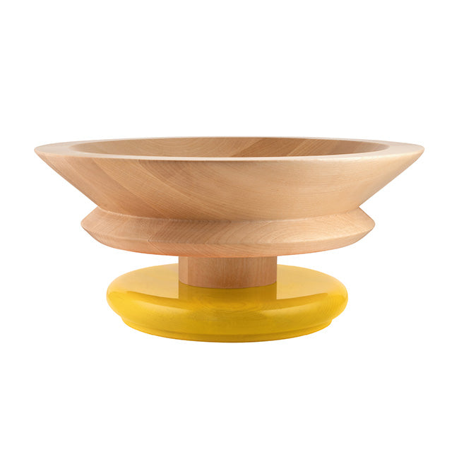 Alessi Twergi fruitschaal, ontwerp Ettore Sottsass, in blank hout met gele basis, zijaanzicht.
