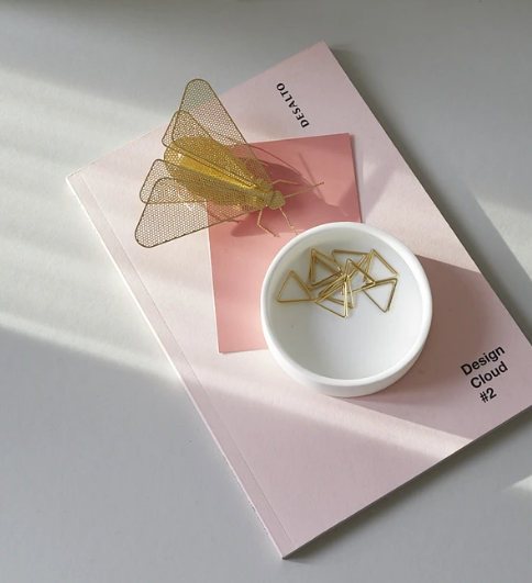 Kleine mot als wanddecoratie met bijpassende paperclips