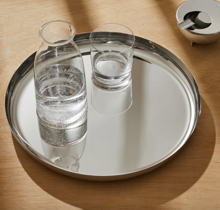 Alessi Tonale karaf, glas, gevuld met water naast een drinkglas op dienblad