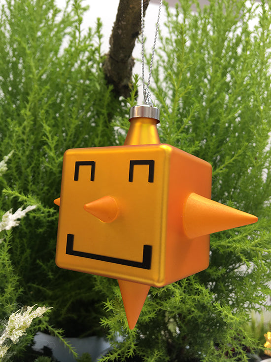 Side view of glass Cubic-Star Christmas bauble, cube shape with face in orange