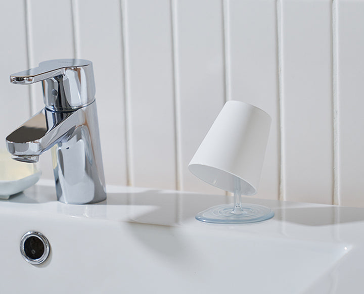 Oh!! bathroom tumbler next to washbasin with tap, side view
