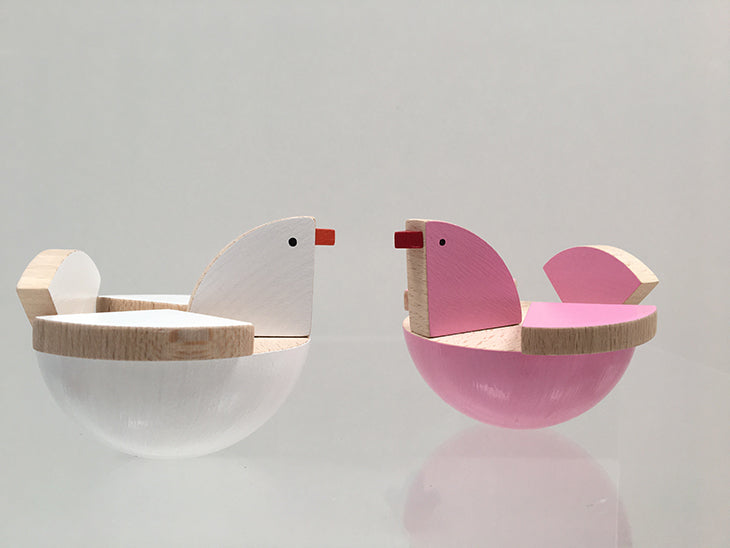KUTULU Holu rocking bird in white next to pink variant from the same series