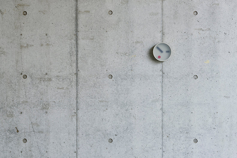 Lemnos Kehai wandklok in grijs, gemonteerd op een muur, ontworpen door Makoto Koizumi