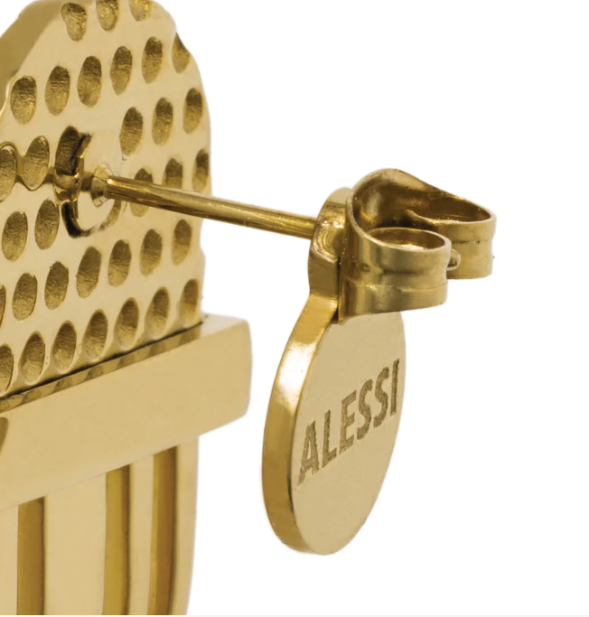 Detail van een bevestiging met gegraveerd Alessi-merkteken in goud