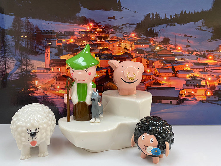 Cagnottone dog next to other figurines from the Happy Eternity collection: shepherd, pig and sheep