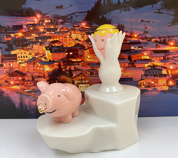 Alessi Geluksvarken Porca figurine next to angel figurine from the happy Eternity collection