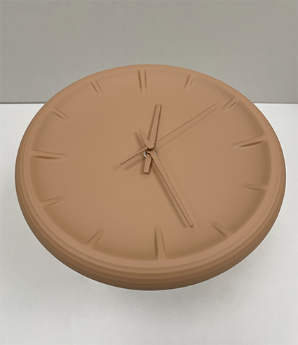 Relief ceramic wall clock in brown, at an angle
