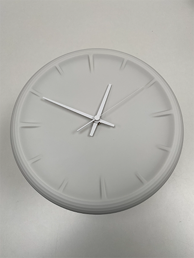 Relief ceramic wall clock in white, top view