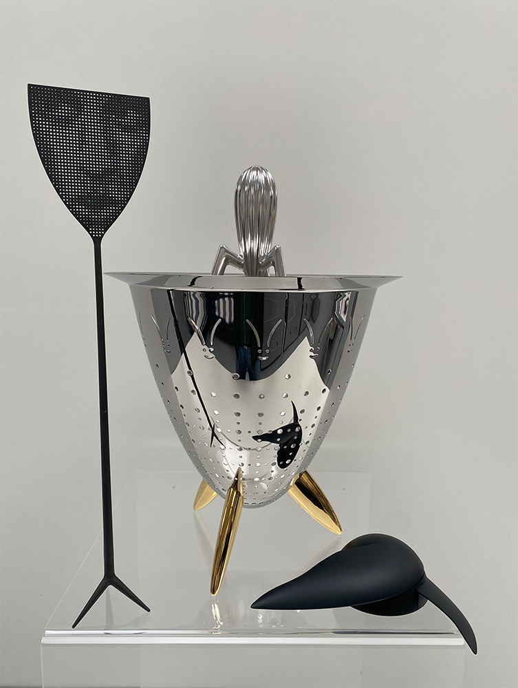 Alessi Dr. Skud fly swatter in grey next to other Alessi accessories