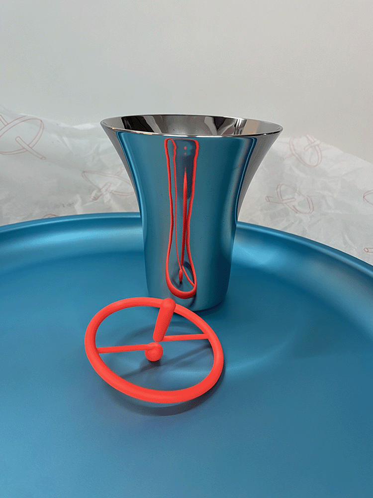 Discolo tray in blue with mug and small spinning top on it