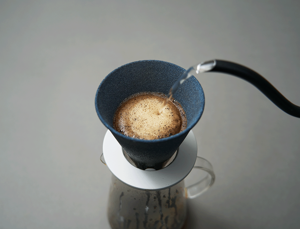 Alessi Cerapotta ceramic coffee filter in use, water poured over cup