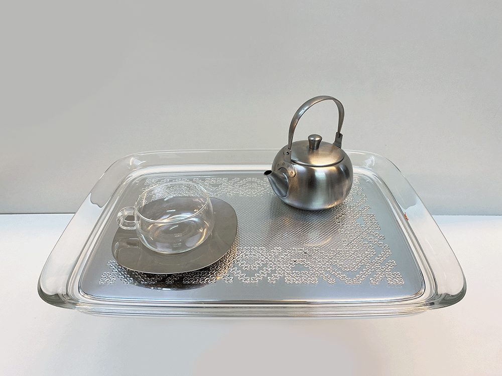 Kartell Teatime tray in chrome, with teapot and cup and saucer