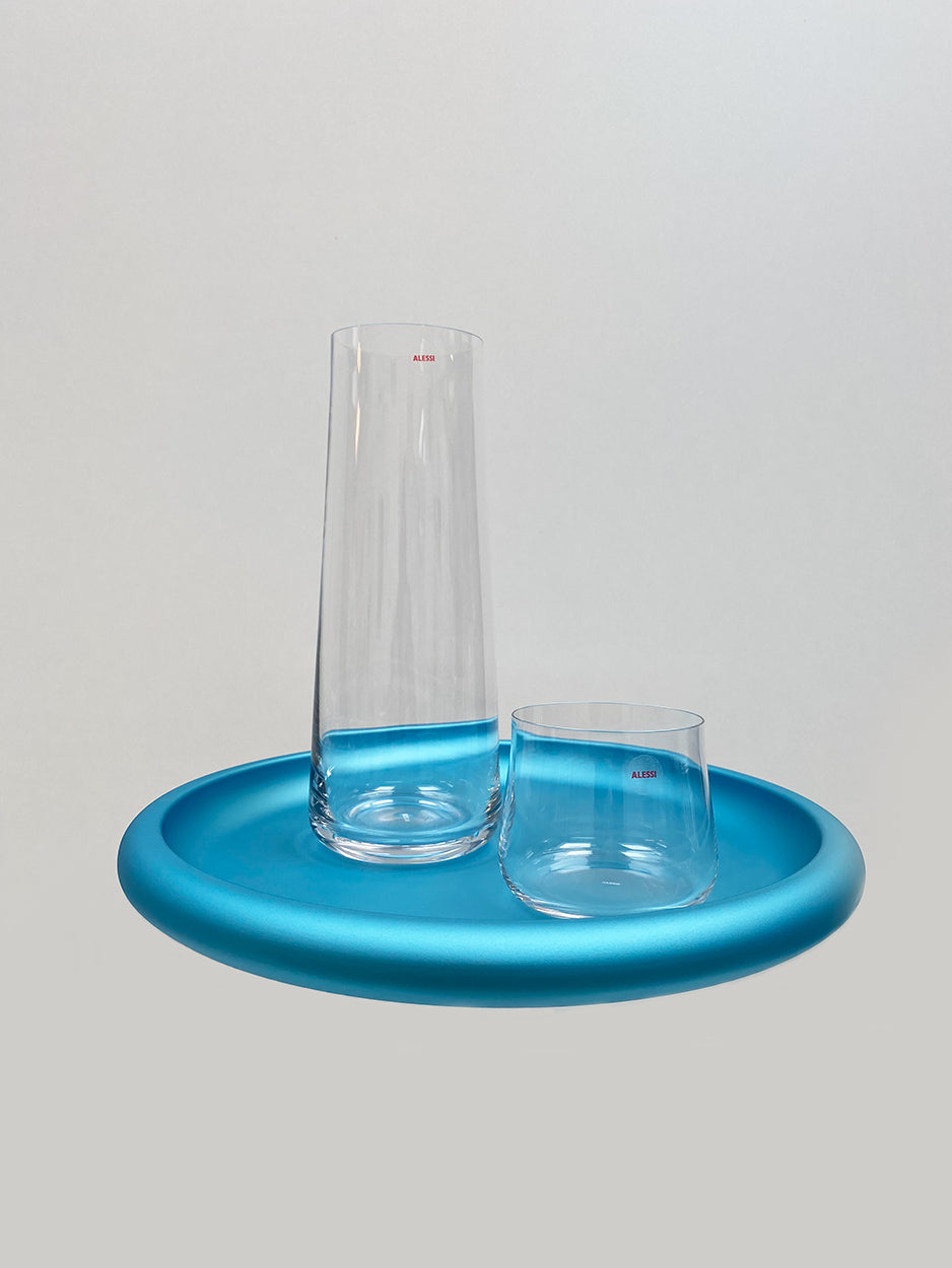 Eugenia carafe and one glass on blue tray, close-up side view