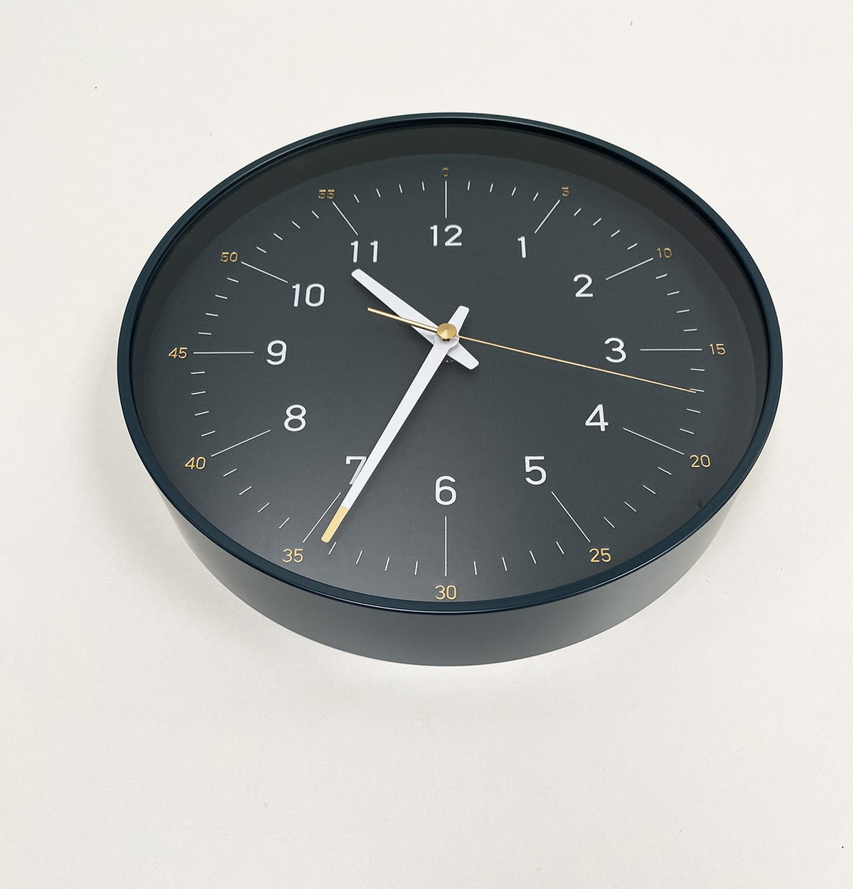Essence Dark Navy clock by Lemnos, at an angle showing case edge
