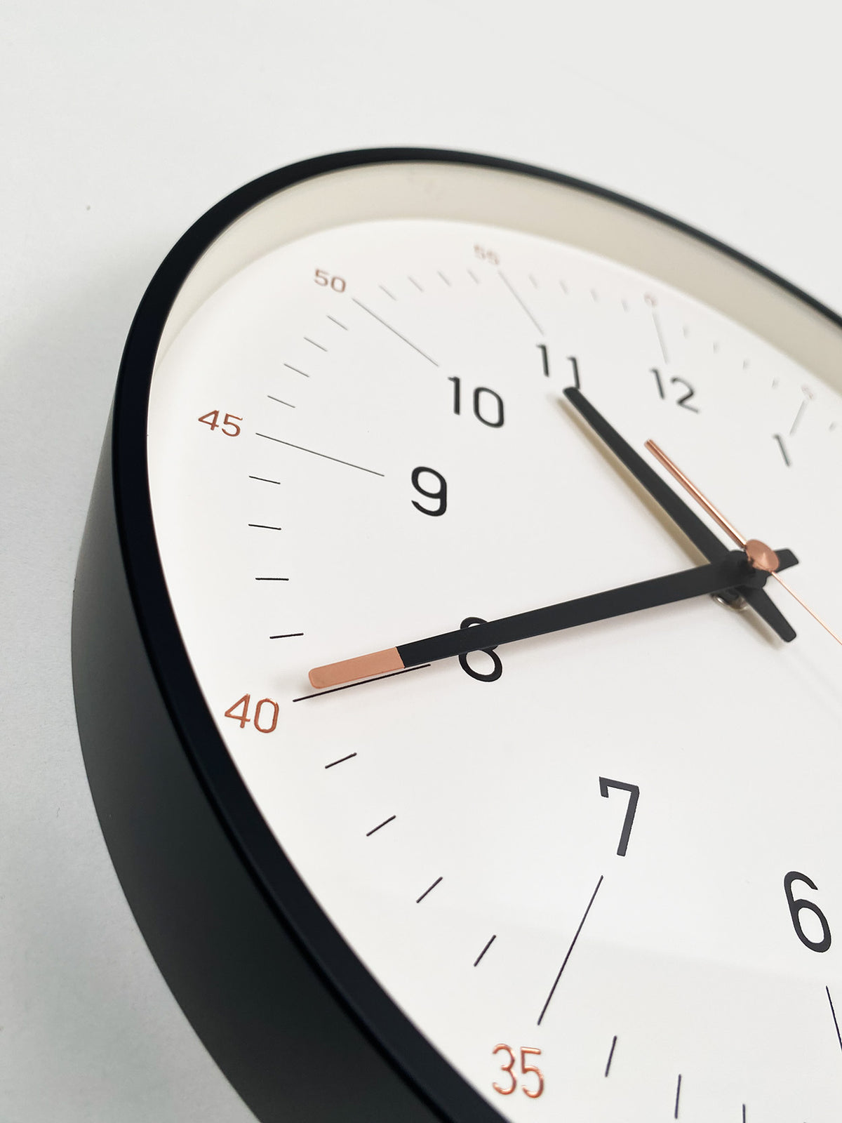 Detail of dial with hour and minute markers in black and orange