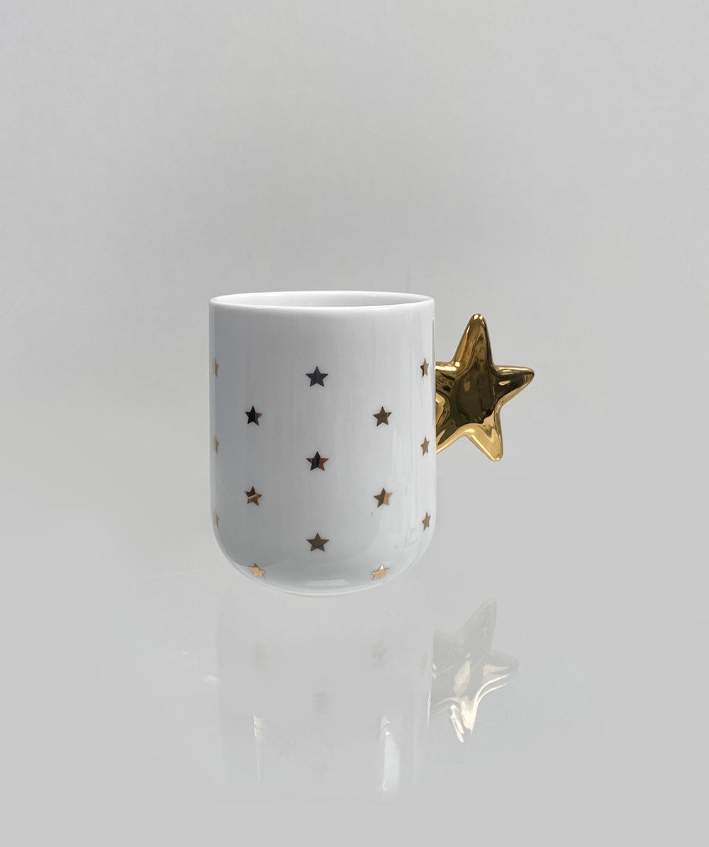 Delight kerst mok van Alessi, wit met gouden sterren en stervormig handvat, ontwerp Nika Zupanc