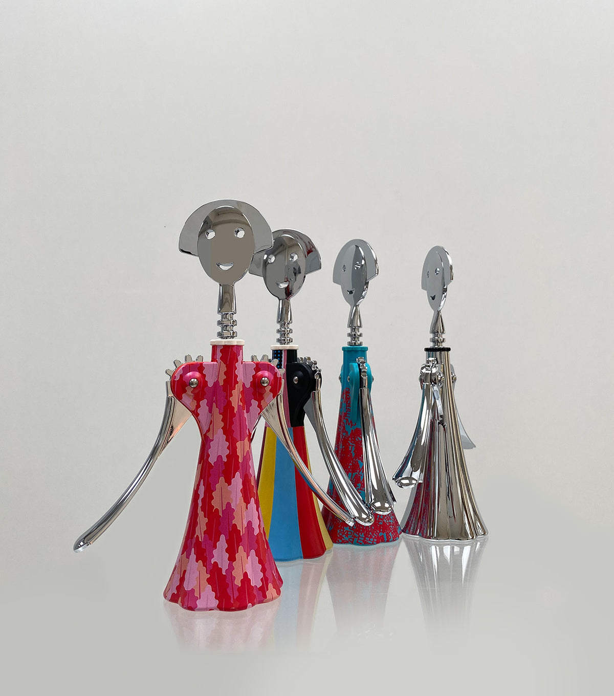 Corkscrew Anna Arborea by Alessi next to three other editions