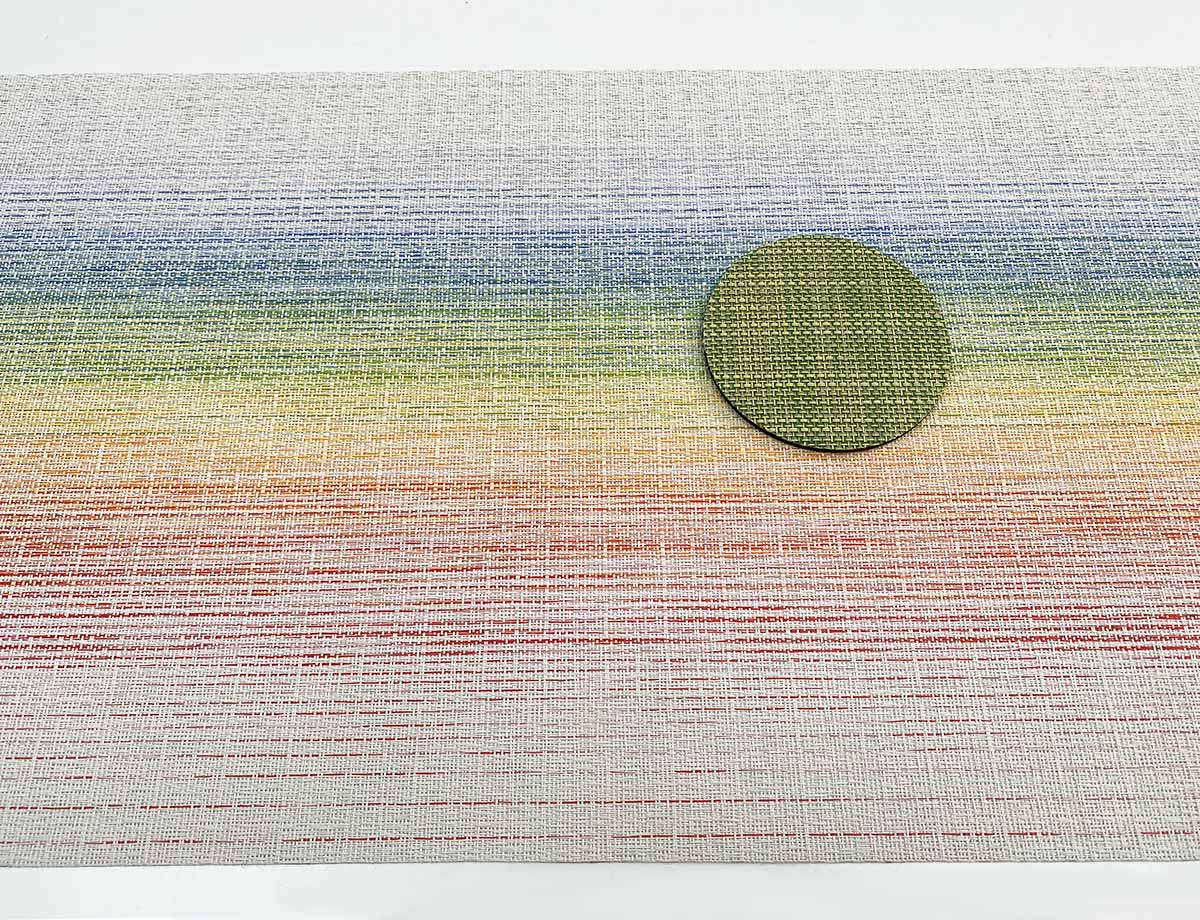 Chilewich Dill coaster in green tone on rainbow-coloured placemat