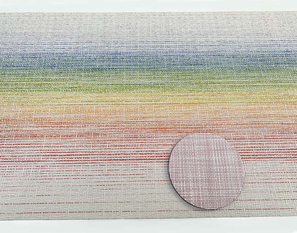 Detail of woven surface in blush, with rainbow-coloured placemat behind