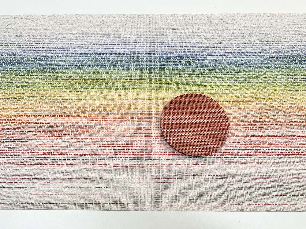 Beautiful terracotta coaster, Mini Basketweave series, on rainbow-coloured placemat