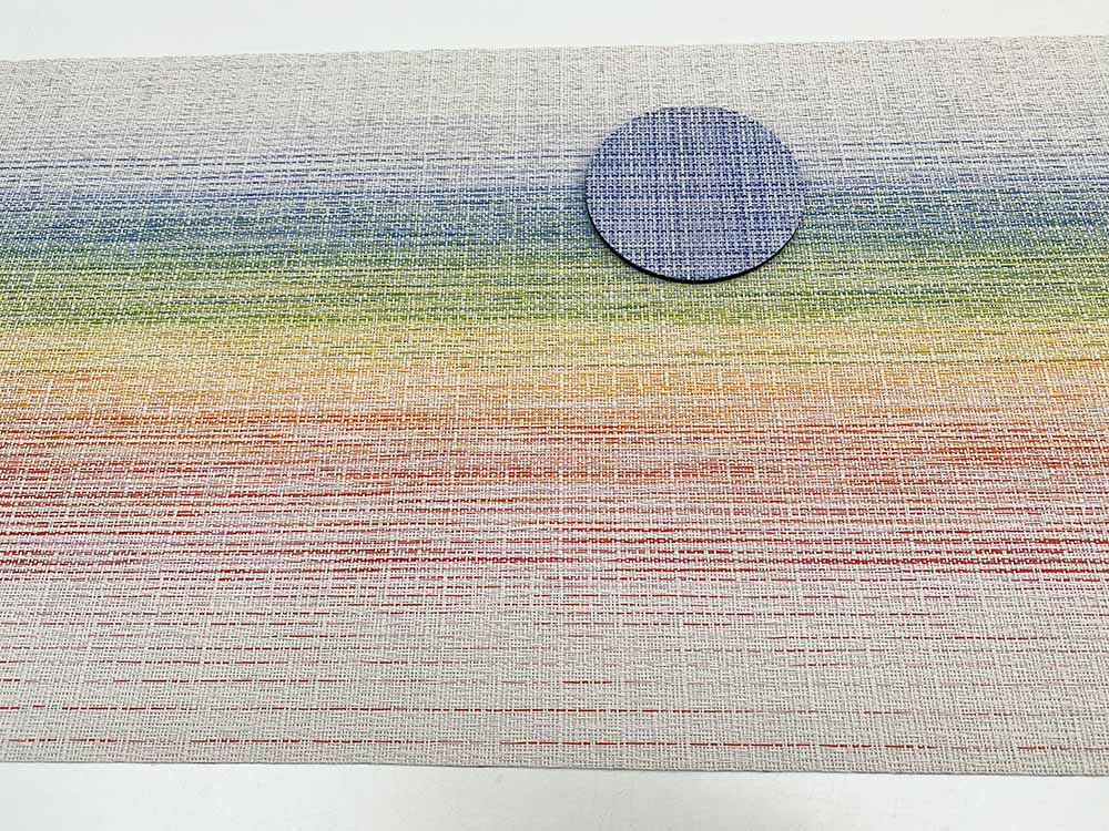 Coaster from the Mini Basketweave series next to placemat in rainbow colours, blue-purple