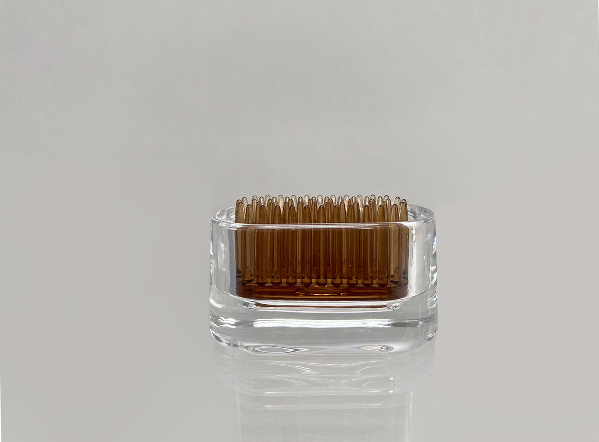 Front view of small oval glass Michi-Kusa vase with brown insert net