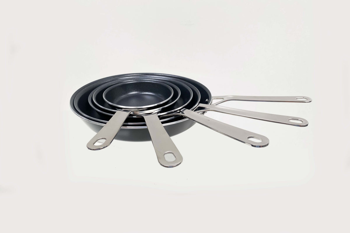 Series frying pans with ceramic base in various sizes side by side