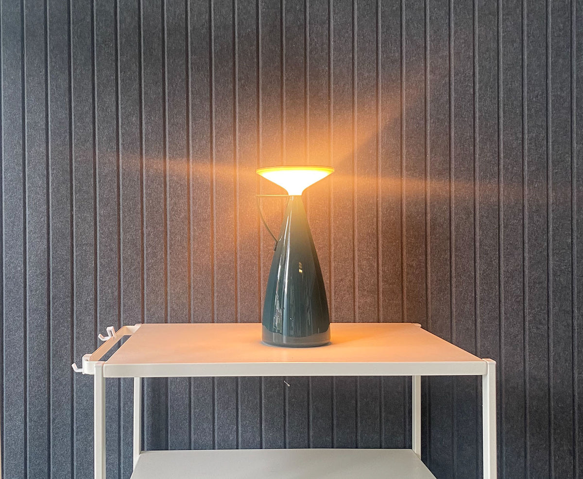 Camomille table lamp in petrol, lit light on a cart