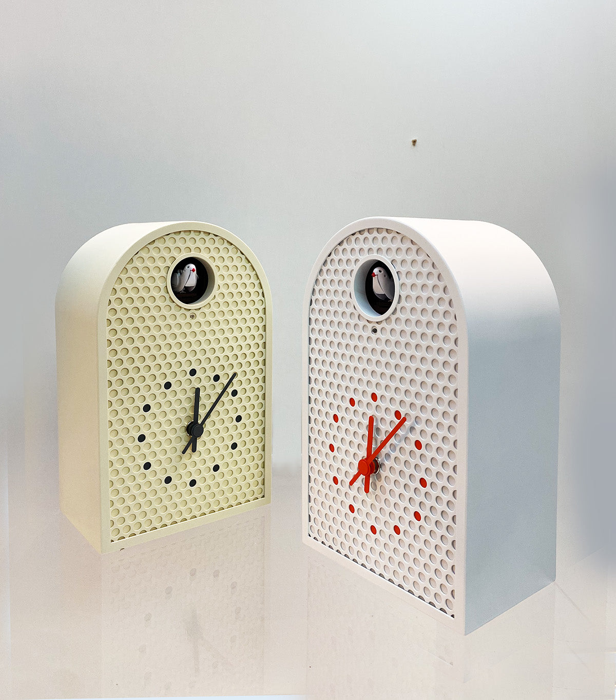 Lemnos Coo cuckoo clock in ivory and white side by side