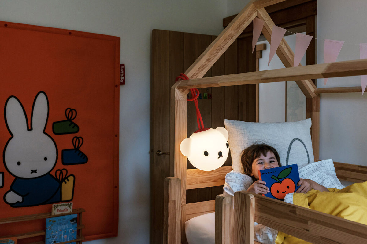 Fatboy Bolleke Boris pendant lamp lit, hanging above a child's bed