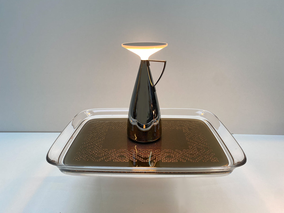 Kartell Camomille table lamp, titanium metallic, side view with lit light